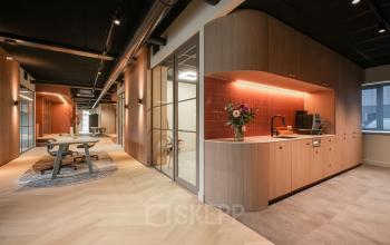 Modern and inviting office space with a stylish kitchenette and comfortable seating at Doornhoek 3745, Veghel, suitable for office space rental.
