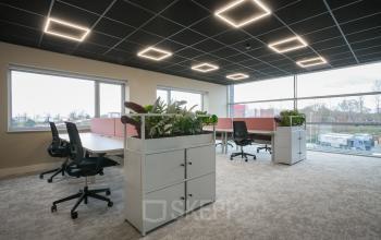 Modern office space at Doornhoek 3745, Veghel, featuring large windows, stylish lighting, and chic workstations perfect for office space rental.
