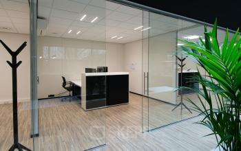 Modern office space featuring sleek wooden flooring and glass partitions at Gildestraat 13, Velp. Perfect for your next office space rental.