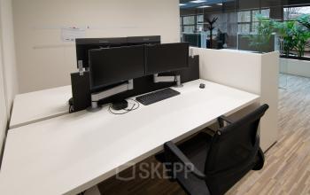 Modern office workspaces available for rent at Gildestraat 13, Velp. The interior features sleek desks with dual monitors, ready for immediate office space rental.