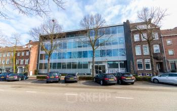 A modern glass-fronted office building located at Kaldenkerkerweg 20, Venlo, with parking spaces in front, perfect for your next office space rental.