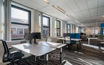 Bright, modern office space with multiple desks and chairs, featuring large windows for natural light at Lange Dreef 10, Vianen Utr. Ideal for office space rental.