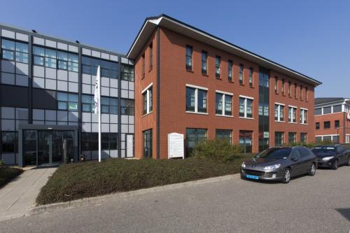 Exterior view of an office building located at Lange Dreef 11***, Vianen Utr, with brick and glass facade and adjacent parked cars.