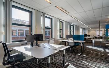Bright workspace at Lange Dreef 17, Vianen Utr, featuring large windows, contemporary office furniture, and modern lighting, perfect for office space rental.