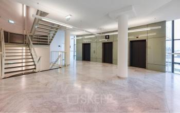 Spacious interior of Regulusweg 11, Voorburg, showcasing elevator lobby, ideal for office space rental with sleek design.
