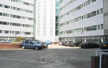 Parking area of the office building at Regulusweg 11 in Voorburg, suitable for those seeking convenient office space rental.