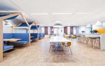 Bright office space for rent in Voorburg at Loire 104 - 206, featuring modern furnishings and collaborative workspaces with ample seating and natural light.