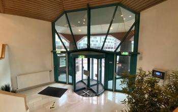 Spacious entrance with large glass doors at Loire 104 - 206 in Voorburg, offering a professional setting perfect for office space rental.