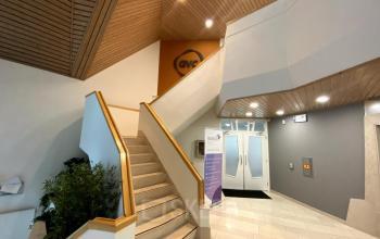 An inviting entrance at Loire 104 - 206, Voorburg, perfect for your next office space rental. Stylish indoor architecture leads to rentable spaces above.