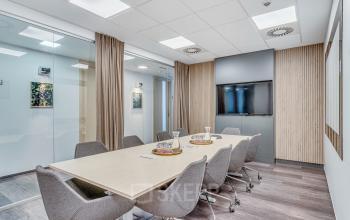 Współczesna sala konferencyjna w biurze na wynajem przy Zajęcza 15 w Warszawa Śródmieście, wyposażona w duży stół, krzesła i ekran prezentacyjny.