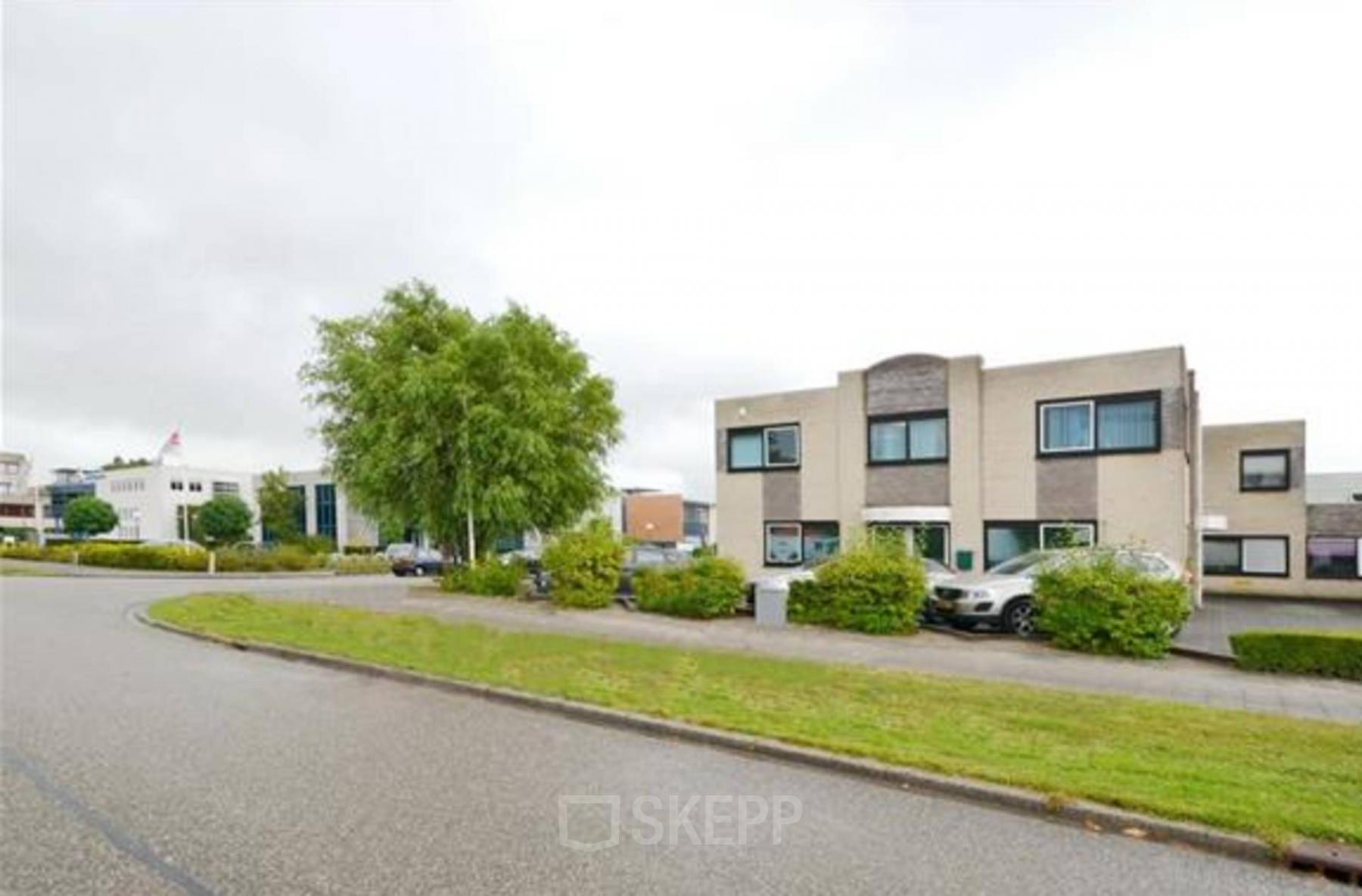 Exterior view of office building located at Pelmolenlaan 17A, Woerden, showing a two-story structure with a parking lot in front.