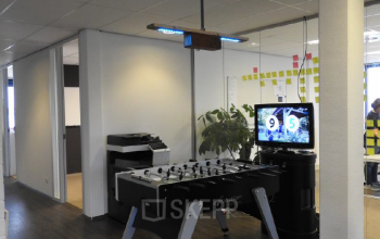 Modern office space rental at Pompmolenlaan 9, in Woerden with a foosball table and casual seating area for a creative work environment.