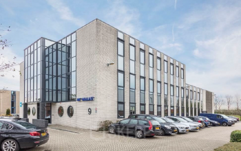 Contemporary office space rental at Pompmolenlaan 9, Woerden with parked cars outside the modern building façade.