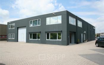 Exterior view of office space rental at Touwslagersweg 6, Woerden; modern building with large windows and parking space.