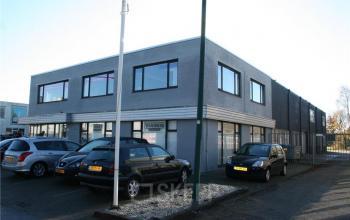 Modern office space rental at Touwslagersweg 6 in Woerden with a professional exterior facade and ample parking.