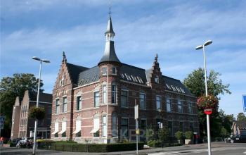 Exterior of a historic office building at Westdam 3D in Woerden, Woerden with classic architecture and a pointed tower, available for office space rental.