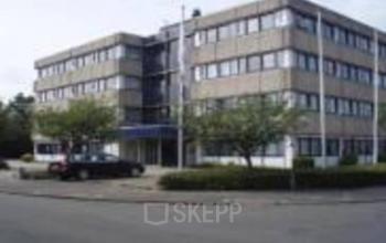 Office space rental available at Zaagmolenlaan 12, Woerden featuring a modern office building with ample parking.