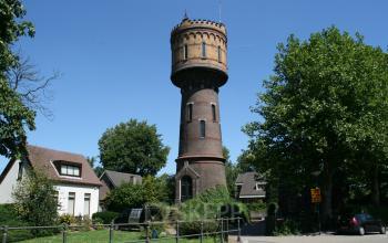 Unique office space rental in Woerden's historical Zaagmolenlaan 12 tower surrounded by lush greenery.