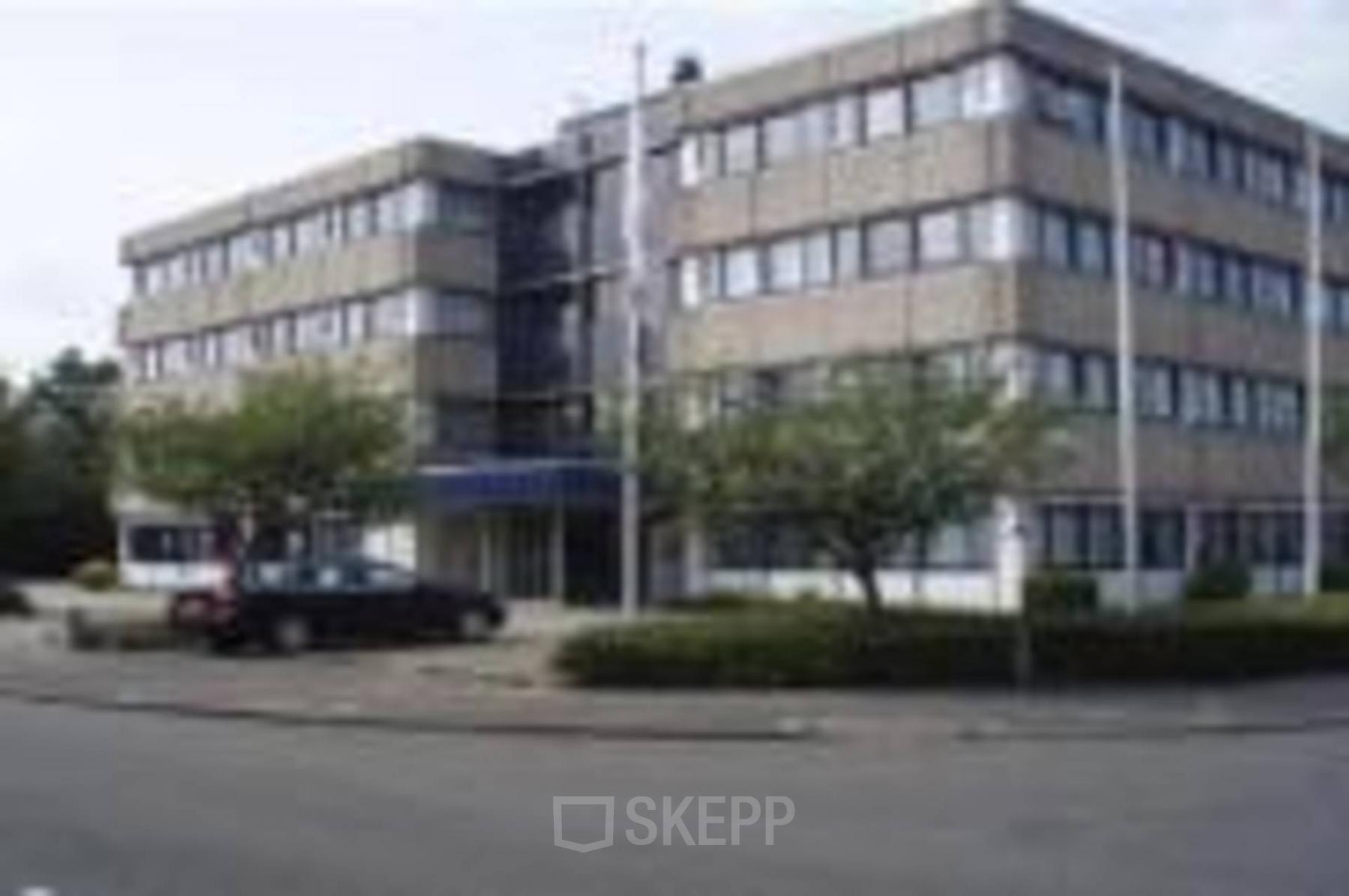 Office space rental available at Zaagmolenlaan 12, Woerden featuring a modern office building with ample parking.