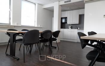 Office space at Pompmolenlaan 18, Woerden with desks, chairs, and a kitchenette, available for office space rental.