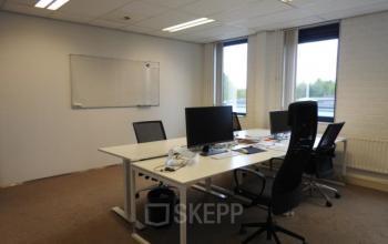 Interior office space at Pompmolenlaan 9, Woerden, featuring a furnished workspace with desks, chairs, and computer monitors, ideal for office space rental.