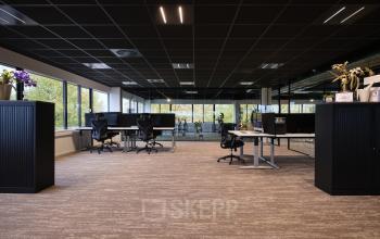 Spacious office interior at Vijzelmolenlaan 9, Woerden, featuring modern workspaces with desks, chairs, and natural light. Ideal for office space rental.