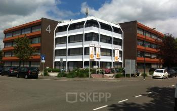 Exterior view of the office building at Zaagmolenlaan 4, Woerden, Woerden, showcasing its modern architecture and surrounding parking area.