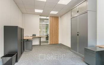 A furnished office space with modern cabinets and a desk, suitable for those looking for an office to rent at Huis ter Heideweg 24, Zeist.