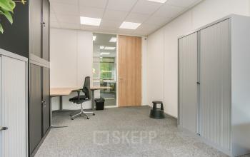 Interior view of office space at Huis ter Heideweg 24, Zeist, featuring a chair, desk, and cabinets for office space rental.