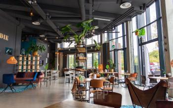 Modern office space at Boerhaavelaan 40 in Zoetermeer with large windows, contemporary furniture, plants, and a bright, open floorplan.
