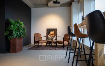 Furnished office space at Boerhaavelaan 40, Zoetermeer featuring modern chairs, a table, and a large decorative plant near the window.