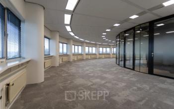 Spacious office space at Boerhaavelaan 40, Zoetermeer, featuring large windows and modern glass partitions. Ideal for office space rental with natural light.