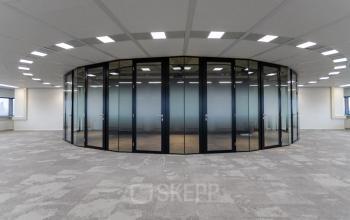 Modern office space with circular glass-walled room at Boerhaavelaan 40 in Zoetermeer, ideal for office space rental.