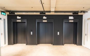 Three black elevators in a modern office building at Boerhaavelaan 40, Zoetermeer.