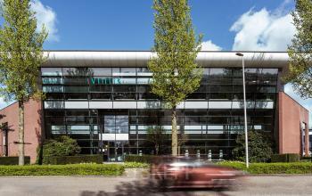 Exterior view of the office building at Edelgasstraat 101, Zoetermeer, showcasing a modern design with glass elements, ideal for renting office space.