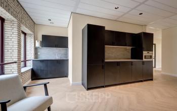 Modern office space at Edelgasstraat 101, Zoetermeer, featuring sleek cabinets and a cozy atmosphere, perfect for office space rental.