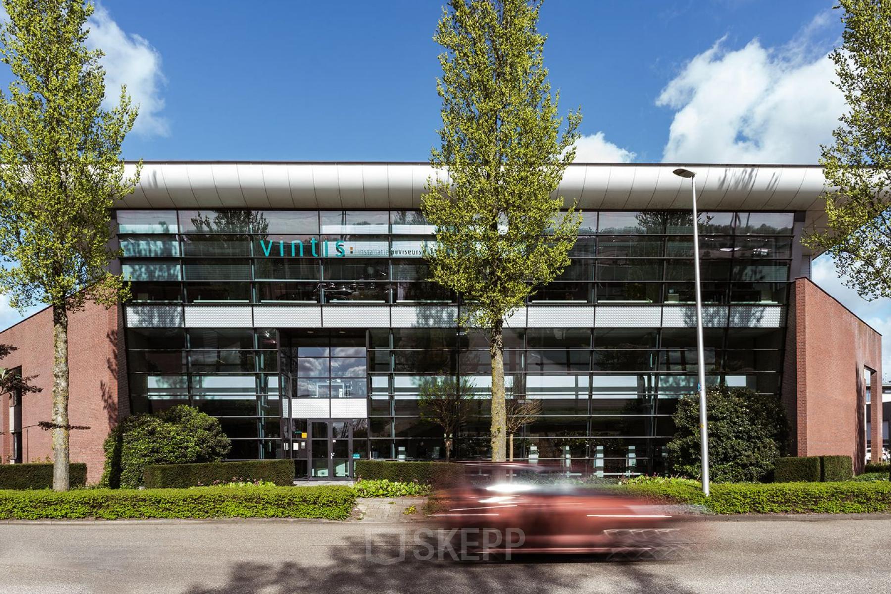 Exterior view of the office building at Edelgasstraat 101, Zoetermeer, showcasing a modern design with glass elements, ideal for renting office space.