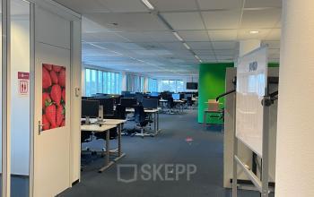 Modern office space available for rent at Baron de Coubertinlaan 35, Zoetermeer. The interior features a spacious, well-lit workspace with desks and chairs.
