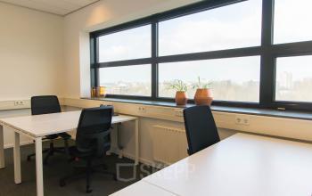 Bright office with large window and workspaces at Louis Braillelaan 80, Zoetermeer, available for office space rental.