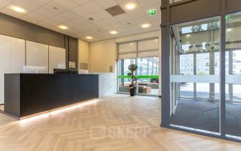 Spacious reception area at the office for rent on Louis Braillelaan 80, Zoetermeer, featuring modern design and elegant flooring. Ideal for office space rental needs.