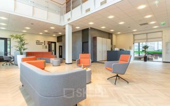 Spacious and modern lobby area at Louis Braillelaan 80, Zoetermeer, ideal for office space rental with stylish furniture and bright lighting.