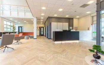 Bright office reception area at Louis Braillelaan 80 in Zoetermeer, offering a sleek office space rental opportunity with modern furnishings and welcoming design.