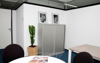 Office space with a closet against the wall