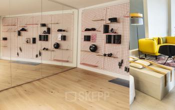 Modernes Büro in einem Open Floorplan mit Holzboden und farbenfrohem Mobiliar am Ernst Nobs Platz 1, Zürich City, ideal zum Büroraum mieten.