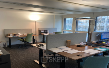 Well-lit office space rental at Dufourstrasse 43, Zürich Seefeld, featuring tidy desks and modern office chairs with personal computers and documents.