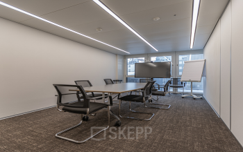 Modern conference room with a large screen and chairs in Dufourstrasse 43, Zurich Seefeld, ideal for an office space rental.
