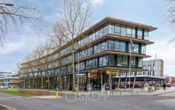 Modern office building at Assendorperdijk 1, Zwolle, available for rent, showcasing expansive glass facades and contemporary architecture. Ideal for office space rental.