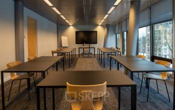 Spacious office for rent at Assendorperdijk 1, Zwolle, featuring multiple tables and chairs, ideal for meetings or collaborative work.