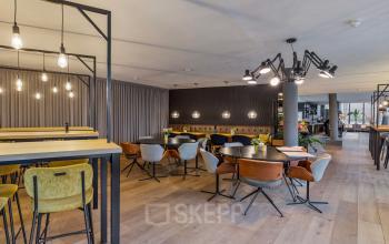 Modern office to rent at Assendorperdijk 1 in Zwolle featuring stylish furnishings with multiple seating areas, perfect for collaborative work.