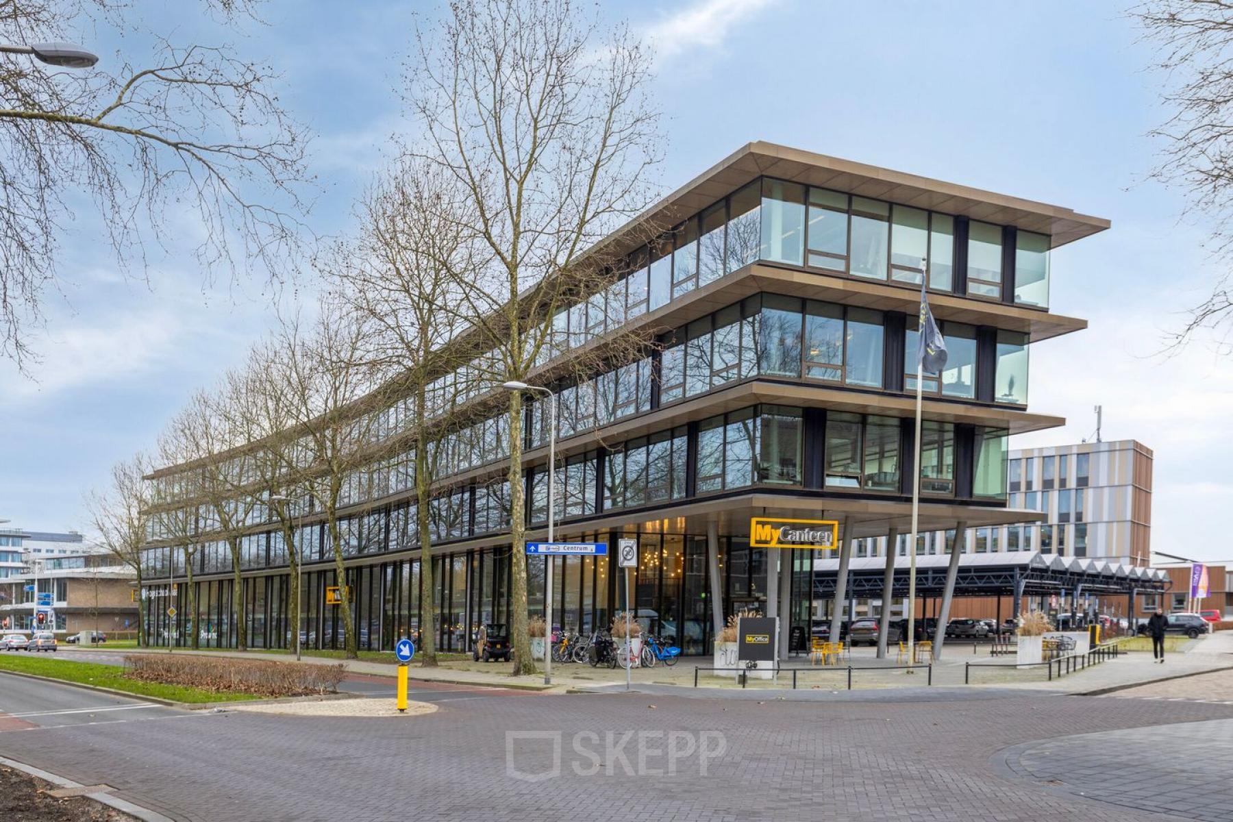 Modern office building at Assendorperdijk 1, Zwolle, available for rent, showcasing expansive glass facades and contemporary architecture. Ideal for office space rental.